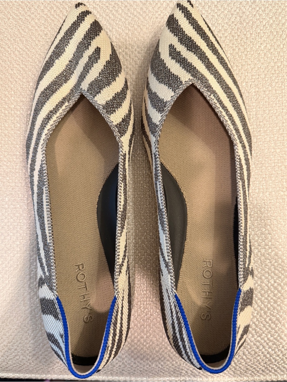 Rothy's Zebra-Print Pointed Flats in Black & White with Blue Trim
